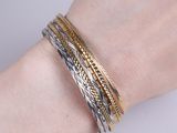 a close up of a person ' s arm with a bracelet on it