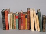 a lot of books that are lined up on a table