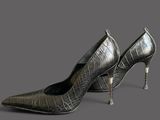 a close up of a pair of high heeled shoes on a gray surface
