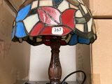 a lamp that is sitting on a table next to a box