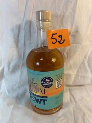 a bottle of liquor sitting on a table with a price tag on it