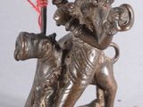 a statue of a woman riding a horse with a basket on her back
