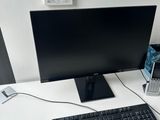 a computer desk with a keyboard and a monitor on it