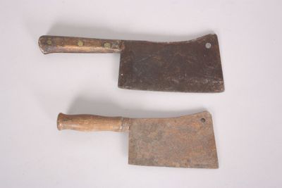 two old tools that are on a white surface