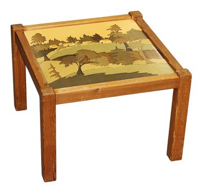 a small wooden table with a painting on the top of it