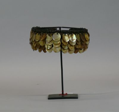 a table lamp made out of coins on a metal stand