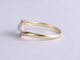 a yellow gold ring with a single diamond in the middle