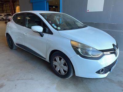 a white car is parked in a garage next to a blue wall