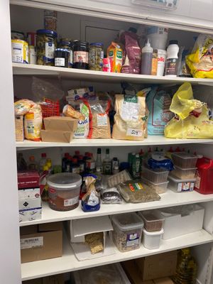 a pantry full of food and condiments on the shelves