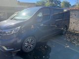 a black van parked in a parking lot in front of a building