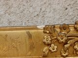 a close up of a gold plate with flowers on it