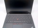 a close up of a laptop with a keyboard on a white surface