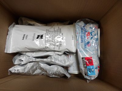 a cardboard box filled with a lot of bags of toilet paper