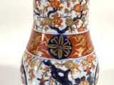 an image of a vase with a bird and flowers on it