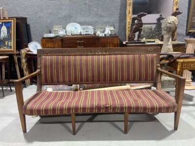 a couch with a baseball bat on it in a room