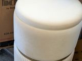 a white stool that is sitting in front of a box