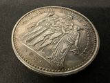 a close up of a coin on a table with a black background