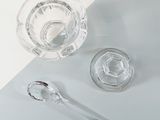two spoons and a glass of water on a table