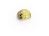 a yellow quartz stone on a white surface