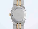 an image of a silver and gold wrist watch on a white surface