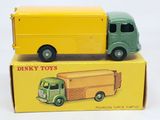 a yellow box with a green truck and a yellow box with a green truck