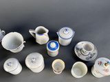 many different types of teapots and cups on the table