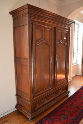 a large wooden cabinet in the middle of a room