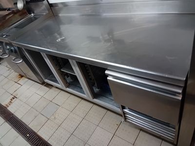 a stainless steel counter top in a commercial kitchen