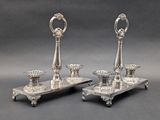 pair of silver plated candlesticks on stand with ornate decoration