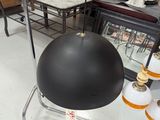 a black ball on a metal stand in a store