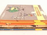several children ' s books stacked on top of each other on a table