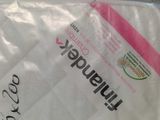 a bag of toilet paper that has a pink ribbon on it