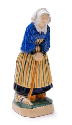 figurine of an old woman with a broom on a white background