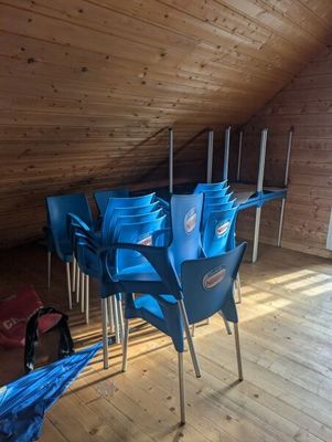 many blue chairs in a room with wooden walls