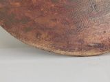 a large brown bowl sitting on a white surface