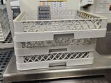 a stack of dishes sitting on top of a stove in a kitchen