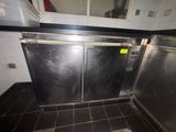 stainless steel double doors in a commercial kitchen with tile flooring
