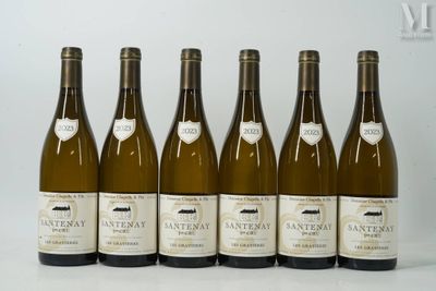 six bottles of wine are lined up in a row on a table