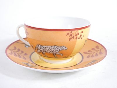 a cup and saucer with a cheetah design on it