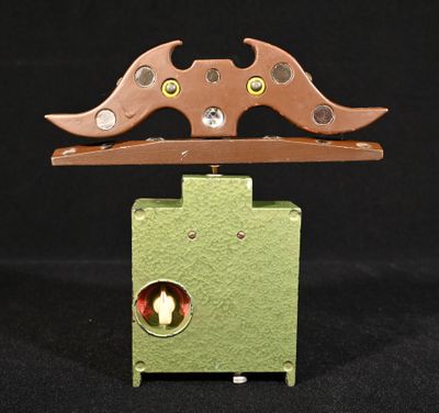une boîte verte munie d'une poignée en bois et percée de deux trous