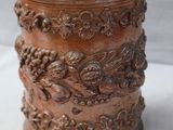 a brown jar with a lid on a white table