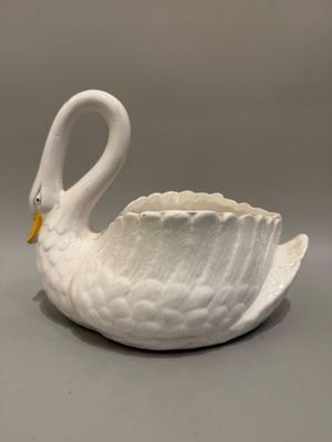 un bol en forme de cygne blanc posé sur une table