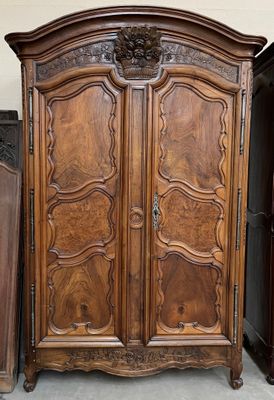 a large wooden armoire with carvings on it