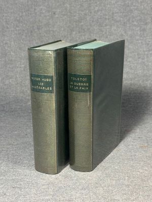 two books sitting on top of a table next to each other