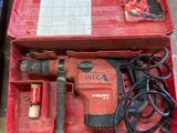 a red tool box with tools in it on the ground
