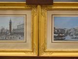 two framed paintings of a view of a city with a clock tower