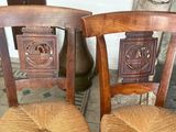 two wooden chairs that are sitting next to each other