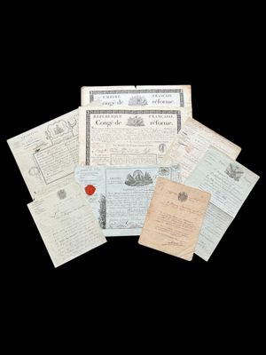an image of a pile of old papers with a red wax stamp on them