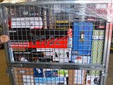 a man that is standing next to a cart full of boxes
