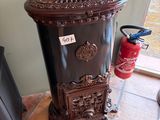 a black fire hydrant sitting on the floor next to a fire hydrant